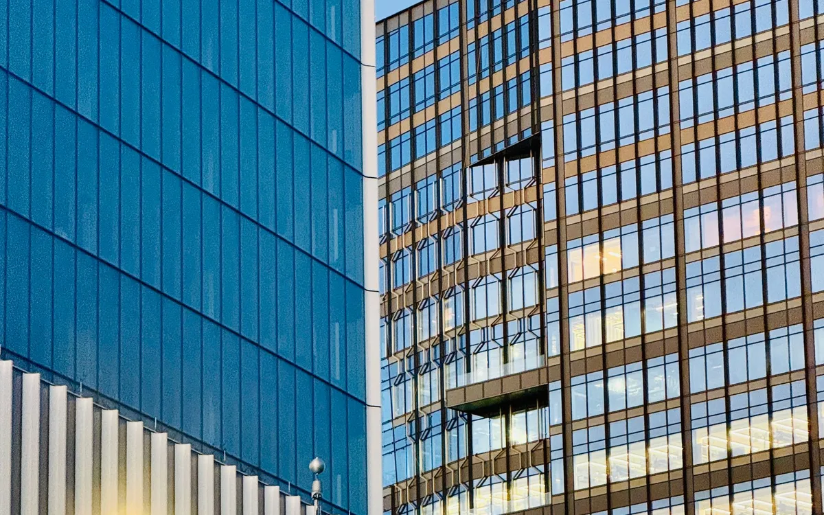 Glass-fronted city buildings in an urban neighborhood