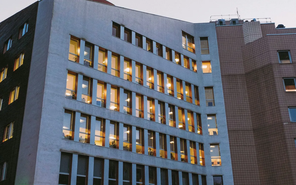Building exterior with rows of illuminated windows